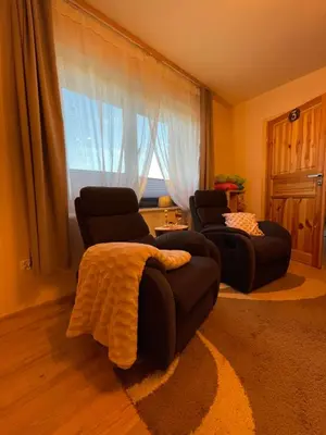 a living room with two chairs and a couch and a window at Przyszowa 441 in Przyszowa