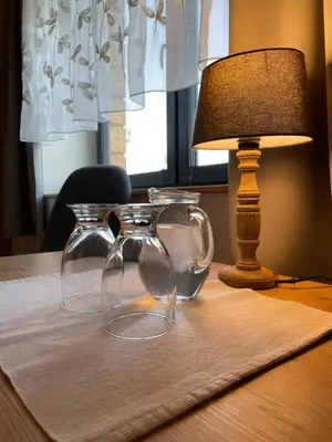 a pair of glasses on a table next to a lamp at Przyszowa 441 in Przyszowa