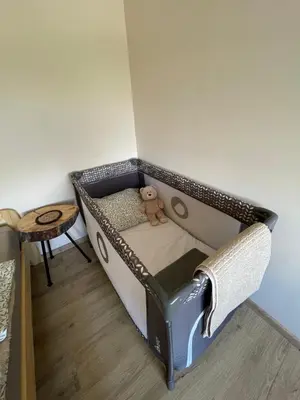 a small bed with a teddy bear in a room at Przyszowa 441 in Przyszowa