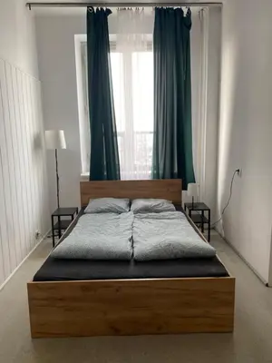a bedroom with a wooden bed with a window at Best View Old Town Rooms in Kraków