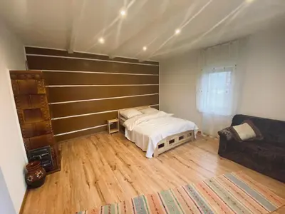 a bedroom with a bed and a couch in it at Na Łachówce in Skawa