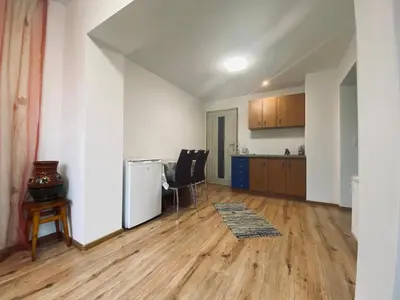 an empty living room with a kitchen and a table at Na Łachówce in Skawa
