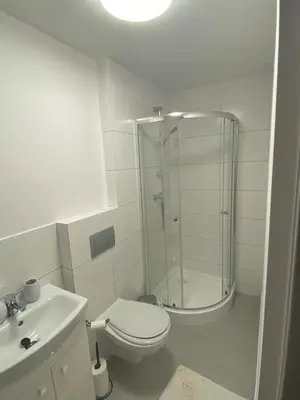 a bathroom with a shower and a toilet and a sink at Na Łachówce in Skawa