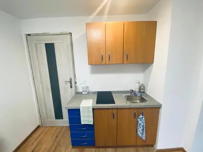 a small kitchen with a sink and a mirror at Na Łachówce in Skawa
