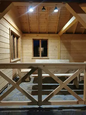 a log cabin with a large table in the center at Predlówka - Na dachu Świata in Zawoja