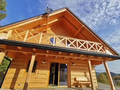 a log cabin with a large roof at Predlówka - Na dachu Świata in Zawoja