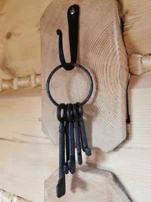 a group of black crosses hanging on a piece of wood at Predlówka - Na dachu Świata in Zawoja