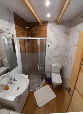 a bathroom with a shower and a sink and a toilet at Słodki Zakątek Spa Jacuzzi&Sauna in Sobolów