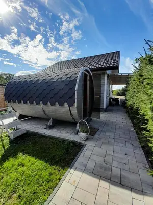 a house with a pitched roof on a patio at Słodki Zakątek Spa Jacuzzi&Sauna in Sobolów