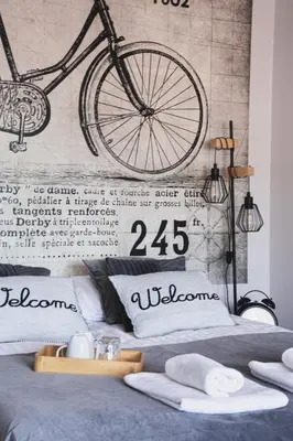a bicycle mural above a bed in a bedroom at Całorocznik Skała & Apartamenty in Ryczów