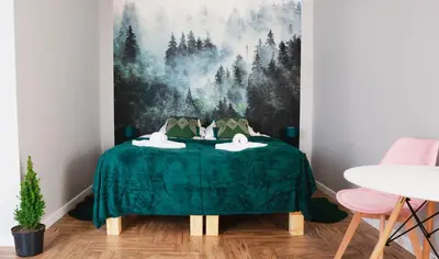a room with a green table with two swans on it at Całorocznik Skała & Apartamenty in Ryczów