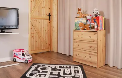 a room with a wooden dresser and a toy car at Całorocznik Skała & Apartamenty in Ryczów