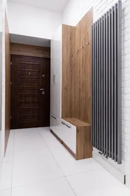 a hallway with a wooden closet and a wooden door at Househost Apartment: Bonerowska 5/11 in Kraków