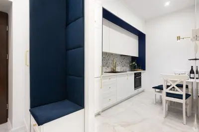 a kitchen with blue walls and a dining room at Blue Residence Orawska 5 in Kraków