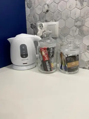a counter with a blender and two glass jars on it at Blue Residence Orawska 5 in Kraków