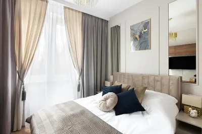 a bedroom with a white bed with blue pillows at Blue Residence Orawska 5 in Kraków