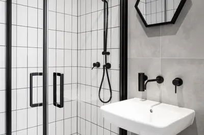 a bathroom with a shower and a sink at HOUSEHOST Apartament: ul. Miodowa 42/42a in Kraków