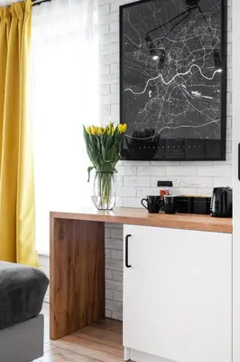 a living room with a table with a vase of flowers at HOUSEHOST Apartament: ul. Miodowa 42/42b in Kraków