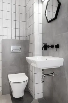 a bathroom with a white sink and a toilet at HOUSEHOST Apartament: ul. Miodowa 42/42b in Kraków