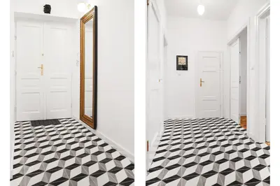 a hallway with a black and white tile floor at HOUSEHOST Apartment :Starowiślna 66/9 Street in Kraków