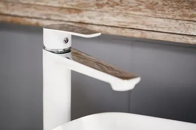 a bathroom sink with a white toilet with a faucet at HOUSEHOST Apartment: Józefa Dietla 73/7 in Kraków