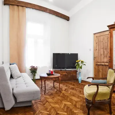 a living room with a couch and a tv at HOUSEHOST Apartment: Józefa Dietla 73/7 in Kraków