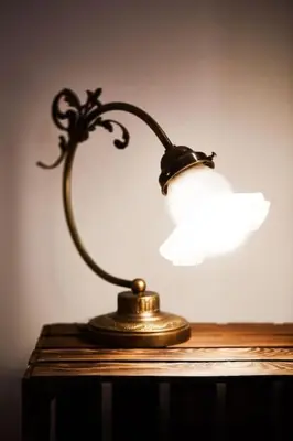 a lamp sitting on top of a wooden table at HOUSEHOST Apartment: Józefa Dietla 73/7 in Kraków