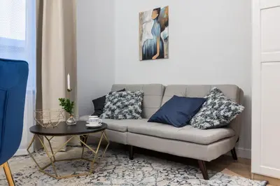 a living room with a couch and a table at HOUSEHOST Apartment: Starowiślna Street 36/27 in Kraków