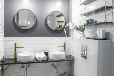 a bathroom with two sinks and two mirrors at HOUSEHOST Apartment: Starowiślna Street 36/27 in Kraków