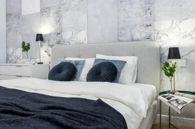 a bedroom with a large white bed with blue pillows at HOUSEHOST Apartment: Starowiślna Street 36/27 in Kraków