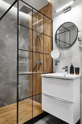 a bathroom with a shower and a sink and a mirror at HOUSEHOST Apartment :Miodowa 42/4a in Kraków