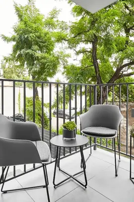 a patio with two chairs and a table at HOUSEHOST Apartment :Miodowa 42/4a in Kraków