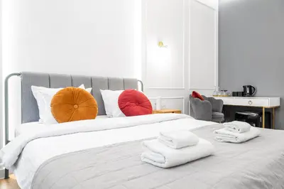 a bedroom with a large bed with towels on it at HOUSEHOST Apartment: Św.Gertrudy 10/2.11 in Kraków