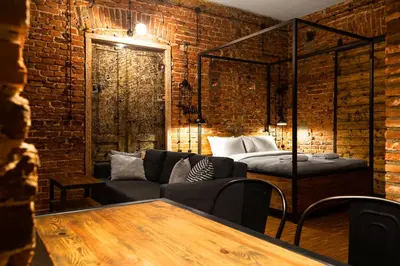a living room with a couch and a bed at HOUSEHOST ApartmenI: Podbrzezie 2/20 in Kraków