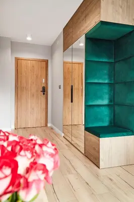 a room with a green bench and wooden doors at HOUSEHOST Apartament :Miodowa 42/4b in Kraków