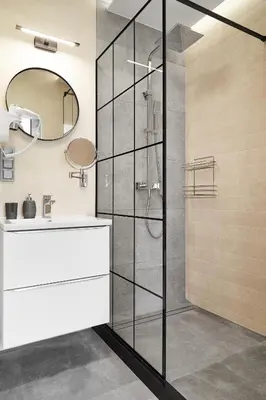 a bathroom with a shower and a sink and a mirror at HOUSEHOST Apartament :Miodowa 42/4b in Kraków