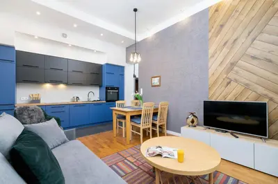 a living room with a couch and a table at Sweet Family Apartment Chodkiewicza Rondo Grzegórzeckie by Noclegi Renters in Kraków