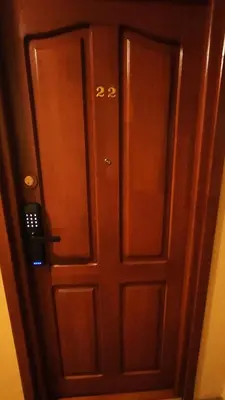 a pair of wooden doors in a room at Studio, Kraków - Czyżyny in Kraków