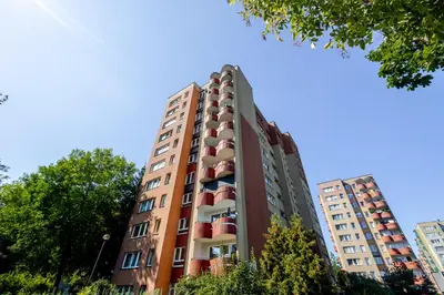 a tall building with red balconies on it at Studio, Kraków - Czyżyny in Kraków