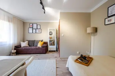 a living room with a couch and a table at Studio, Kraków - Czyżyny in Kraków