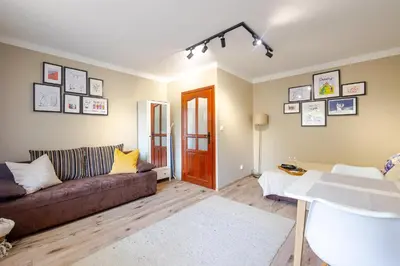 a living room with a couch and a table at Studio, Kraków - Czyżyny in Kraków