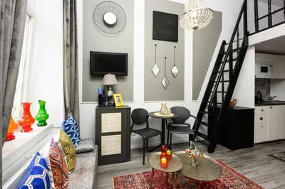 a living room with a staircase and a tv at Native Apartments Studencka 25 in Kraków