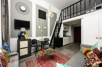 a living room with a couch and a staircase at Native Apartments Studencka 25 in Kraków