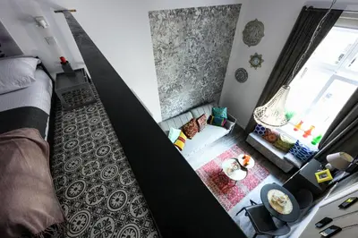 an aerial view of a bedroom with a bed and a window at Native Apartments Studencka 25 in Kraków