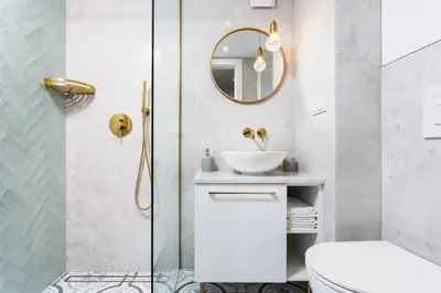 a bathroom with a sink and a toilet and a mirror at City of the Kings-Old Town Pastel Apartment in Kraków