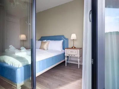 a bedroom with a blue bed and a mirror at Wislane Tarasy by Tyzenhauz in Kraków