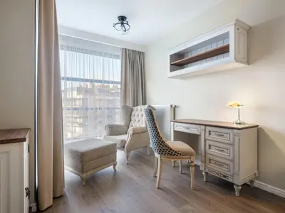 a living room with a desk and a chair and a desk and a chair at Wislane Tarasy by Tyzenhauz in Kraków