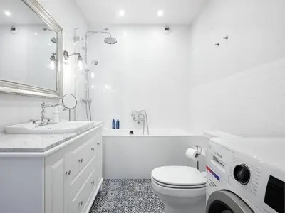 a white bathroom with a toilet and a sink at Wislane Tarasy by Tyzenhauz in Kraków