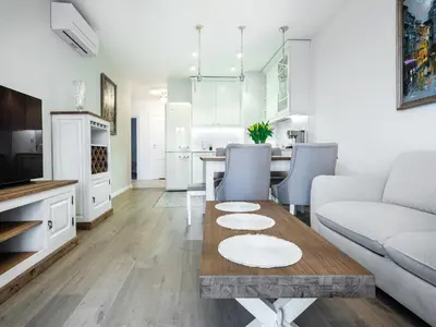 a living room with a couch and a table at Wislane Tarasy by Tyzenhauz in Kraków