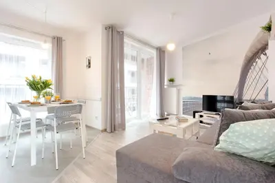 a living room with a couch and a table at Tyzenhauz Apartments Piwna Street in Kraków